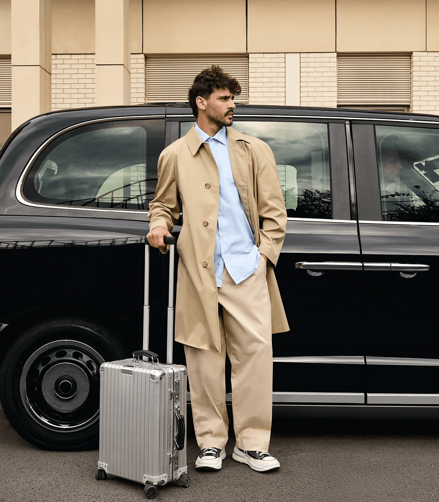 man in front of freenow black cab