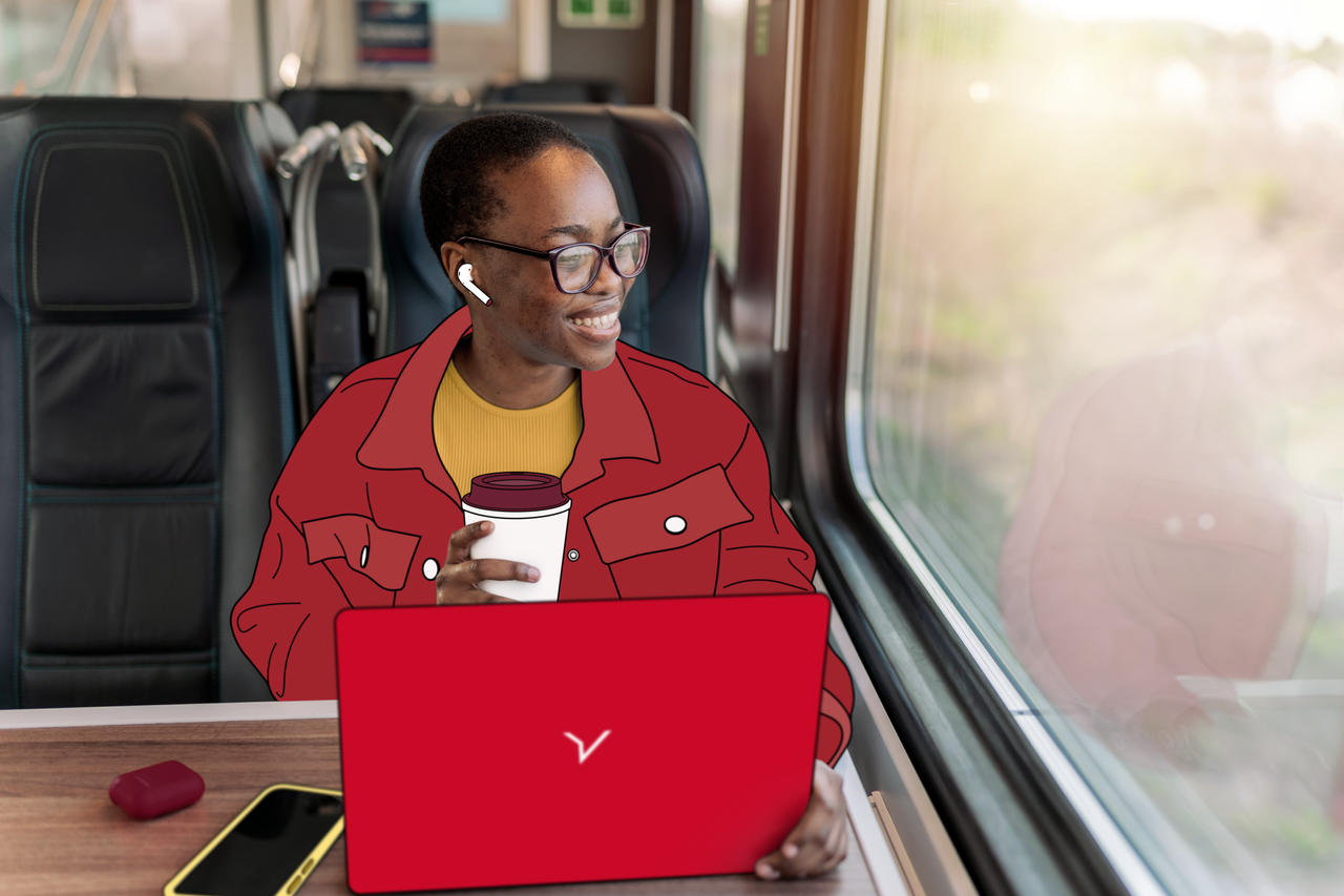 Person on train working on laptop