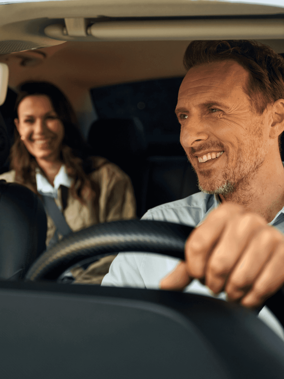 Freenow driver smiling with passenger in back of taxi